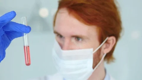 Close Up of Scientist Studying red Solution in Test Tube Stock Footage 80944780