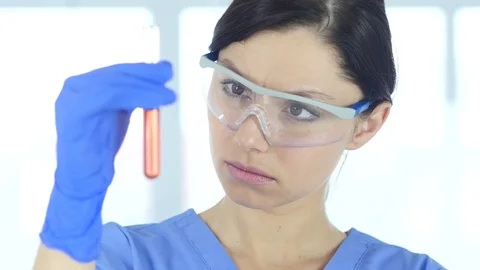 Close Up of Scientist Studying Red Solution in Test Tube Stock Footage 81057220