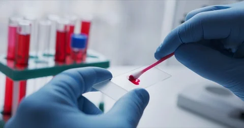 Close- up of scientist studying sample under microscope i Video stock 126164519