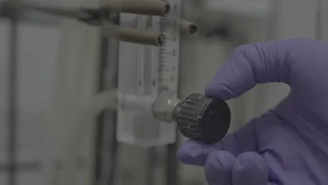 Close-up of scientist turning a knob 스톡 동영상 327632979