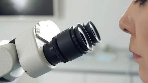 Close-up of a scientist using microscope in a laboratory. Video stock 74584666