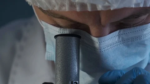Close-up of a scientist using microscope in a laboratory Stock Footage 116112286