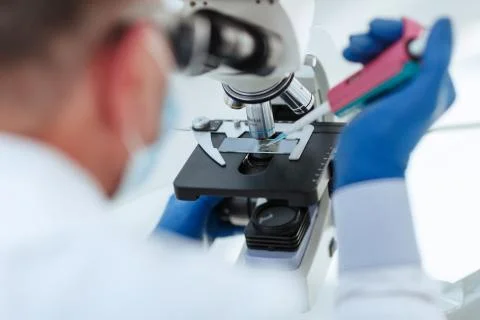 Close up. scientist using a microscope in the laboratory. Stock Photos