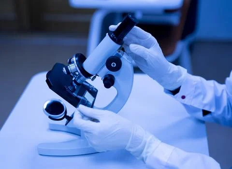 A close up scientist working in the laboratory using  microscope Stock Photos