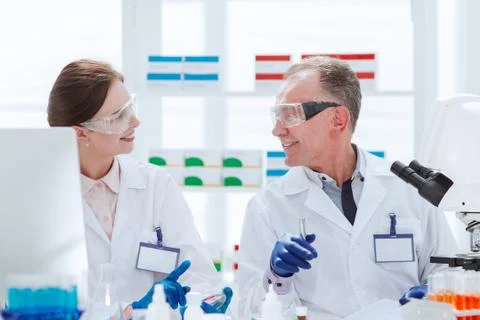 Close up. scientists discussing samples sitting at a laboratory table. Stock Photos