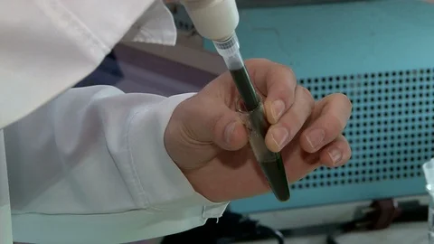 Close-up of a scientist's hand biophysics mixes drugs in a test tube Stock Footage 87906184