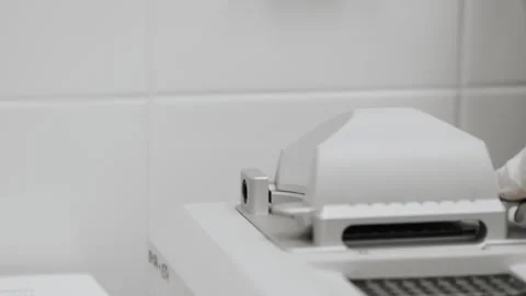 Close-up of a scientists hand closing the lid of a nanodrop. Stock Footage 294535680