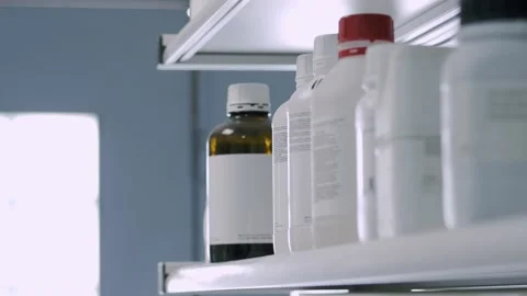 Close-up of scientist's hands placing the bottles in the laboratory Stock-Footage 201897772