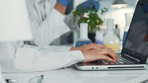 Close-up of scientist's hands using computer in chemistry laboratory Stock Footage 115255306