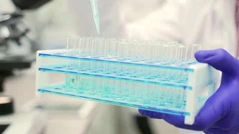 Close up of scientists researcher hands with protective gloves dropping  Stock Footage 233309664