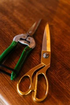 Close-up of scissors and pruning shears on a wooden surface, highlighting sharp Stock Photos