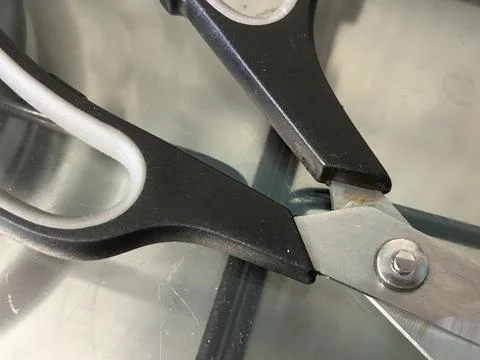 Close-Up of Scissors on a Glass Surface, Black and Silver Design Stock Photos
