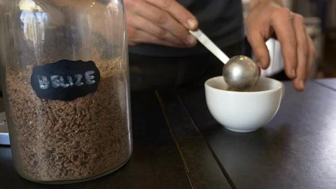 Close-up of scooping chocolate powder into a cup at coffee shop. Stock Footage 100646742