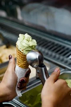Close up scooping ice cream into waffle cone gelato shop concept Stock Photos