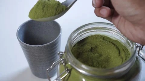 Close-Up of Scooping Moringa Leaf Powder into Cup Stock Footage 314557859