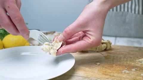 Close-up of scooping out delicious meat a crab and with a fork from the claws. Stock Footage 146334686
