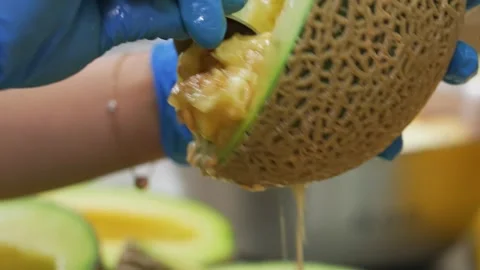 Close Up of Scooping Seeds From Fresh Melon 스톡 동영상 343021291
