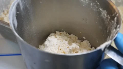Close-up of Scooping White Powder with Orange Scoop into Metal Container Video stock 343027197