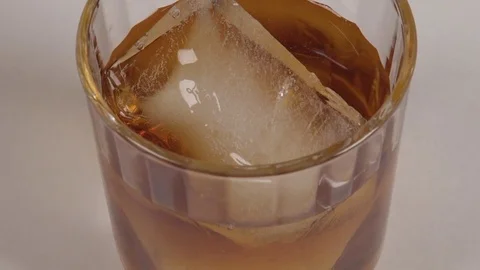 Close-up of Scotch on the rocks in slow motion. Stock Footage 71215083