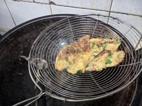 Close-up of a scramble egg being fried in a traditional cast iron wok. Stock Photos