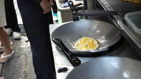 Close up of scrambled egg being made on the side of street, street food stall Stock Footage 301491707