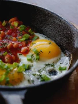 Close-up of scrambled eggs with red beans in a frying pan. English breakfast in Stock Photos