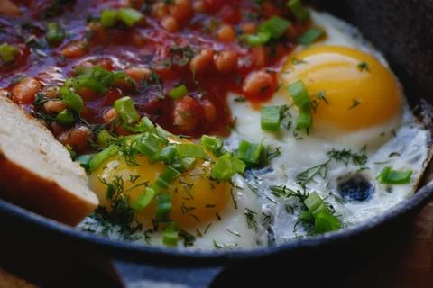 Close-up of scrambled eggs with red beans in a frying pan. English breakfast in Stock Photos