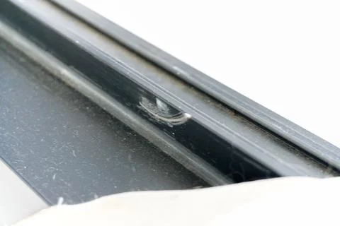 Close up of a scratched black window frame Stock-Fotos