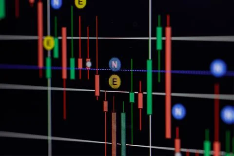 Close up of screen with candlestick chart on dark background. Forex concept. Stockfoto's