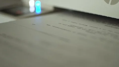 Close-up of screenplay pages printing from office printer in a cinematic static Stock Footage 334811138