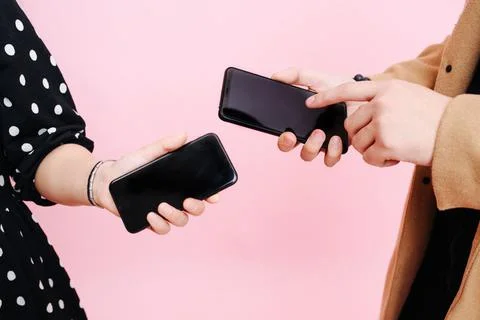Close-up screens phones in the hands of men and women Stock Photos