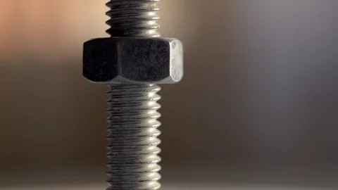 Close-up of screw and nut rotating Stock Footage 77659603
