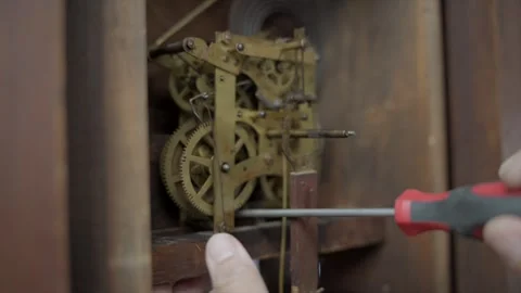 Close up screw driver working on antique clock Stock Footage 341636857