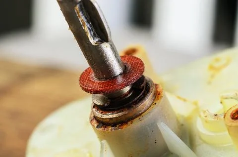 Close-up of a screwdriver and a rusty mechanical component during repair Stock Photos