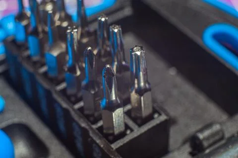 Close up screwdriver with five edges. A set of small screwdrivers. A nozzle o Stock Photos