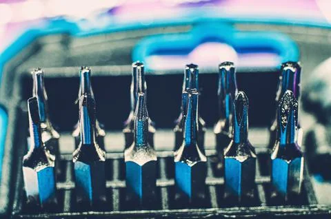 Close up screwdriver with five edges. A set of small screwdrivers. A nozzle o Stock Photos