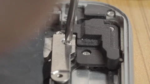 Close up of screwdriver opening smartphone during repair on internal electronic 動画素材 343969825