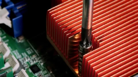 Close-up of a screwdriver securing a red heat sink onto a computer motherbo.. Stock Footage 309698347