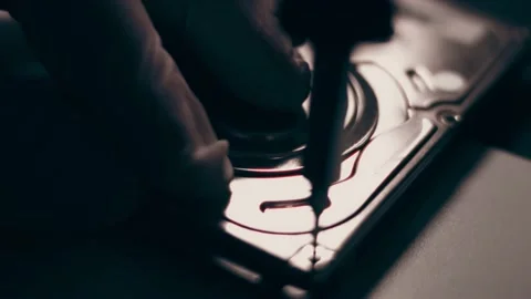 Close-up. Screwdriver unscrews the screw from the computer hard drive. Male 動画素材 233455058