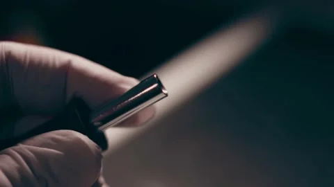 Close-up. Screwdriver unscrews the screw from the computer hard drive. Male 動画素材 233455145