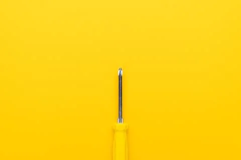 Close-up of screwdriver on yellow background Stock Photos