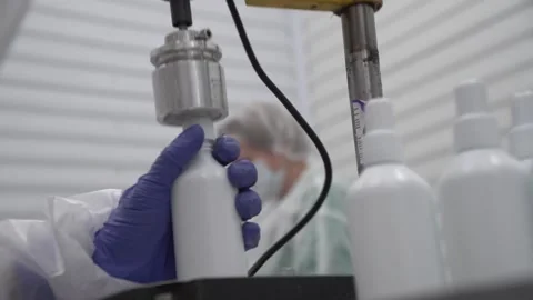 Close up of screwing caps white antiseptic plastic bottles without labels Stock Footage 163408577