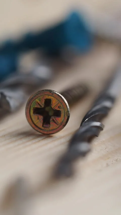 Close up of screws and drill bits on a wooden surface Stock Footage 339830231