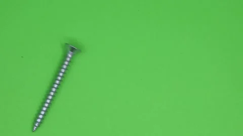 Close-up of  screws isolated on green background Stock Footage 185578271