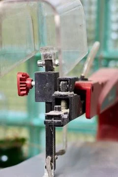 Close-up of a scroll saw in the workshop with metal cutting element. Stock Photos