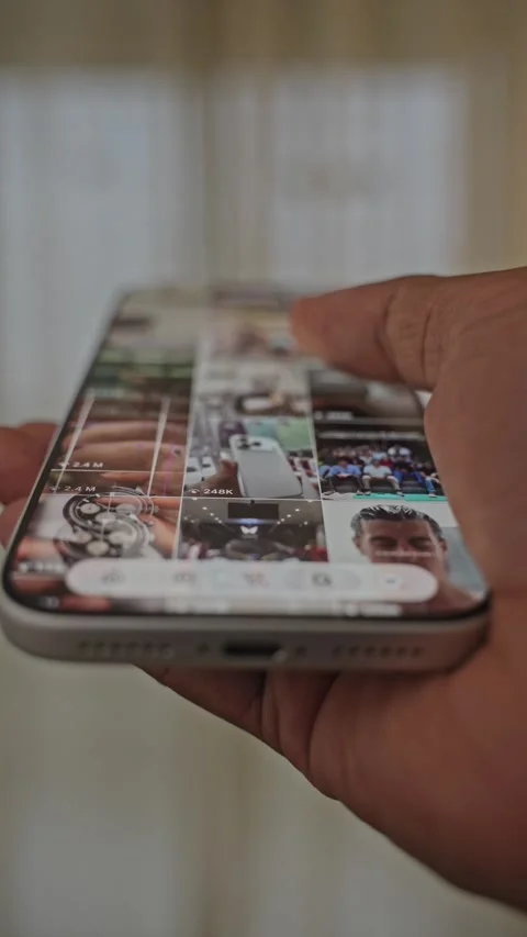 Close-up of scrolling through Instagram Reels, a social media app on a Stock Footage 340415313