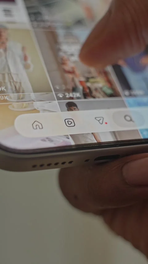 Close-up of scrolling through Instagram Reels, a social media app on a Stock Footage 340415625