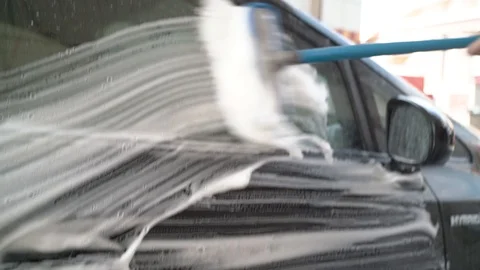 Close up scrubbing soapy brush at hand car wash Stock Footage 115363352