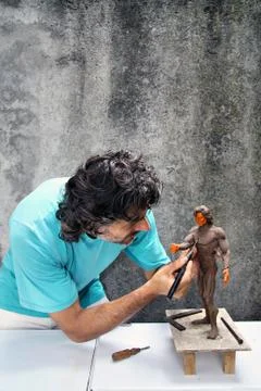 Close up of a sculptor at work on a miniature Stock Photos