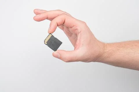 Close up SD memory card in fingers Stock Photos